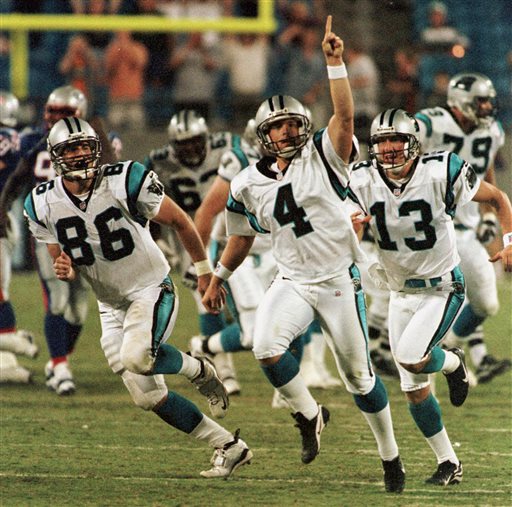 Carolina Panthers kicker John Kasay (4) and holder Ken Walter (13)  celebrate Kasay's 61-yard field goal on the final play of the game to  defeat the New England Patriots 23-20 at Ericsson