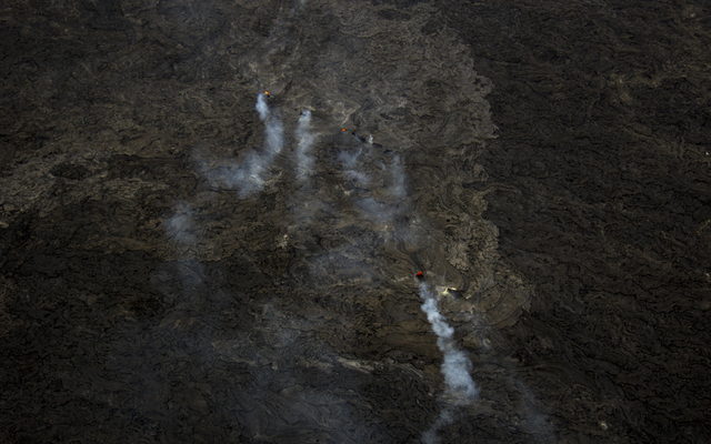 USGS / HAWAIIAN VOLCANO OBSERVATORY                                  A closer look at the breakout point where lava emerged from the tube on November 25. A few skylights provide views of the lava in the new lava tube that formed over the past week on this flow.