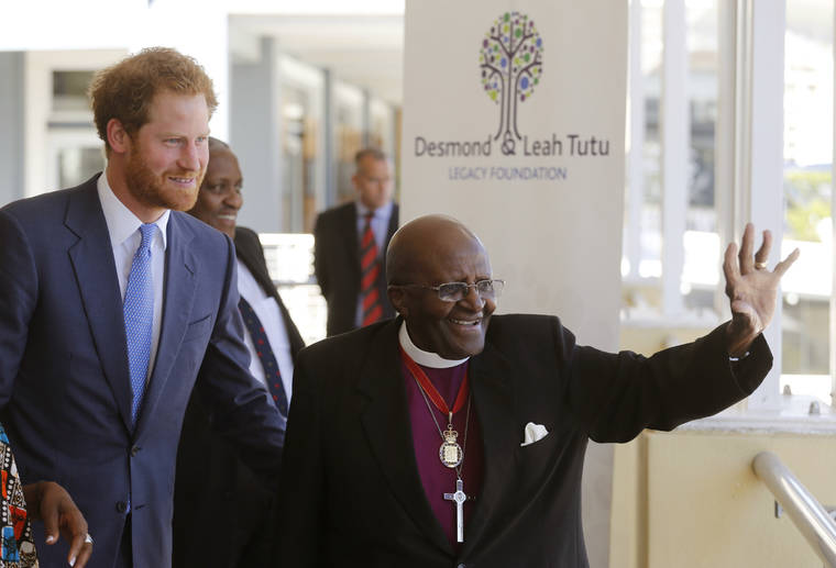 ASSOCIATED PRESS / 2015
                                Britain’s Prince Harry, left, looks on as South African Archbishop Desmond Tutu waves at people during his visit to The Desmond and Leah Tutu Legacy Foundation in Cape Town, South Africa. Prince Harry and his wife, Meghan, along with their infant son, Archie, are making their first official tour as a family, starting Monday and will visit meet with the Tutus.