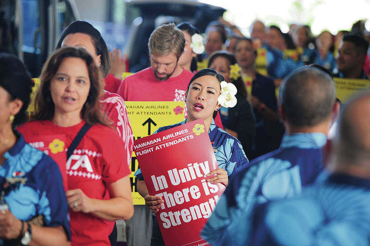 Hawaiian Airlines flight attendants picket in advance of a strike vote