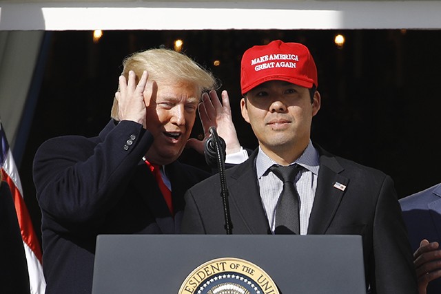 Trump hugs Nationals' Suzuki, who wears MAGA hat at White House