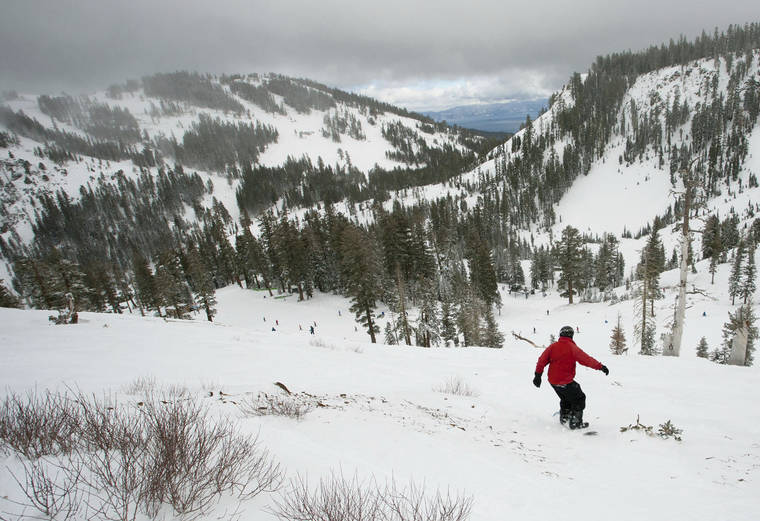 RANDY PENCH/THE SACRAMENTO BEE VIA AP / 2012 A snowboarder drops into a canyon at Alpine Meadows in Lake Tahoe, Calif. Authorities say one person has died and one person is seriously injured after an avalanche at the Northern California ski resort.