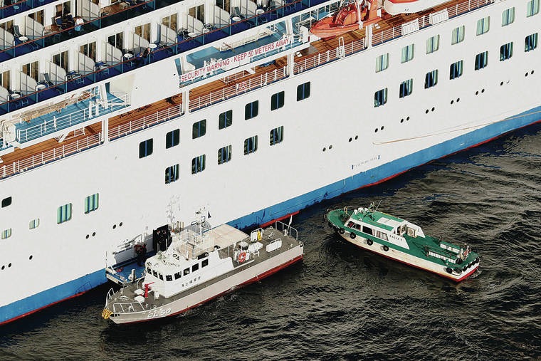 KYODO NEWS VIA ASSOCIATED PRESS 
                                A Japanese Coast Guard patrol boat, left, was brought alongside the cruise ship Diamond Princess today to take passengers tested positive for coronavirus to hospitals off Yokohama, south of Tokyo.