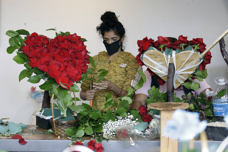 ASSOCIATED PRESS
                                A merchant prepared a floral arrangement, May 10, on Mother’s Day at the Los Angeles Flower Market in Los Angeles. Americans are more unhappy today than they’ve been in nearly 50 years.