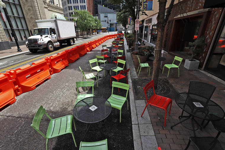 ASSOCIATED PRESS Orange barriers enclose chairs and tables that will be used for dining along Sixth Street between Liberty and Penn avenues in downtown Pittsburgh on June 23. A report by Moody’s Analytics, a private sector economic research firm, released Wednesday, June 24, is warning anew of continuing damage to the economy if Washington doesn’t deliver several hundred billion dollars in budget relief to states and local governments amid the coronavirus pandemic.