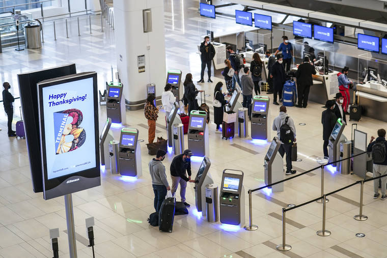 ASSOCIATED PRESS / NOV. 25
                                Travelers wait to check-in for their flights ahead of Thanksgiving at LaGuardia Airport in New York. With some Americans now paying the price for what they did over Thanksgiving, health officials are warning people — begging them, even — not to make the same mistake during the Christmas and New Year’s season.