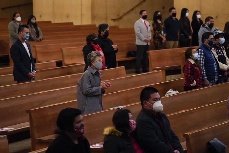 ASSOCIATED PRESS / DEC. 24
                                Worshipers gather for a Christmas Eve Mass inside the Cathedral of Our Lady of the Angels in Los Angeles. California became the first state to record 2 million confirmed coronavirus cases, reaching the milestone on Christmas Eve as nearly the entire state was under a strict stay-at-home order and hospitals were flooded with the largest crush of cases since the pandemic began.