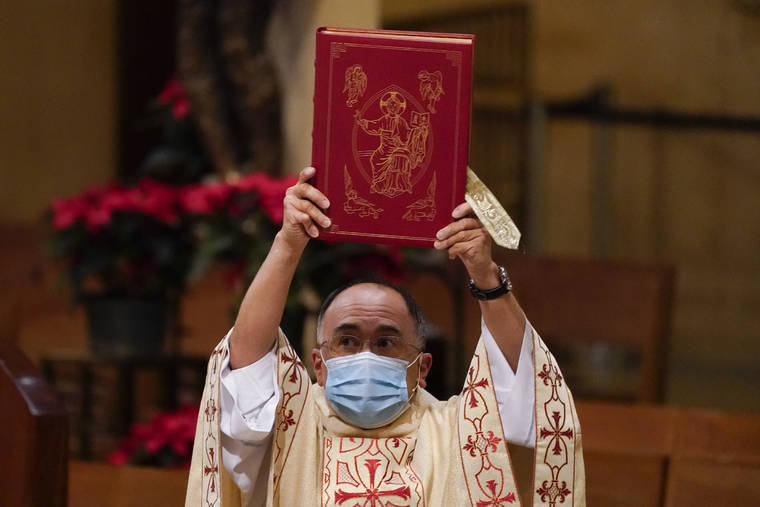 ASSOCIATED PRESS / DEC. 24
                                Father David Gallardo leads Christmas Eve Mass at Cathedral of Our Lady of the Angels in Los Angeles. California became the first state to record 2 million confirmed coronavirus cases, reaching the milestone on Christmas Eve as nearly the entire state was under a strict stay-at-home order and hospitals were flooded with the largest crush of cases since the pandemic began.