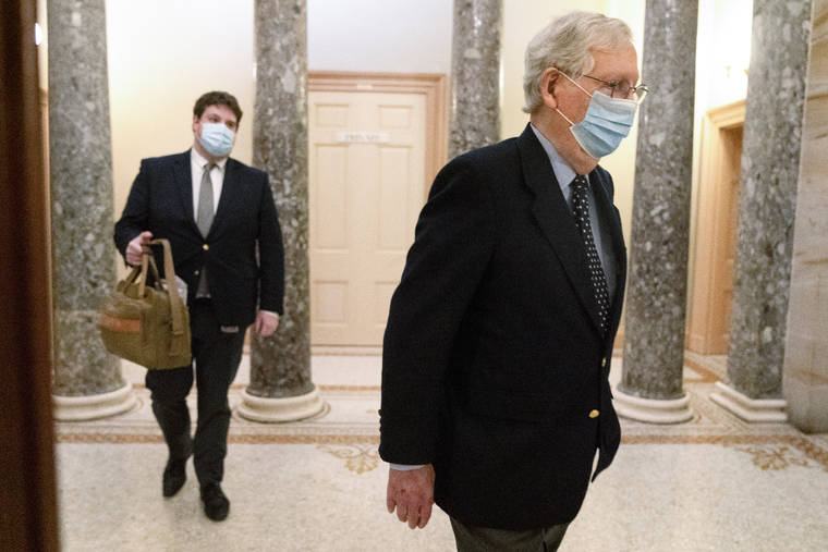 ASSOCIATED PRESS
                                Followed by a staffer holding a bag, Senate Majority Leader Mitch McConnell of Ky., right, left the Capitol for the day, Tuesday, on Capitol Hill in Washington.