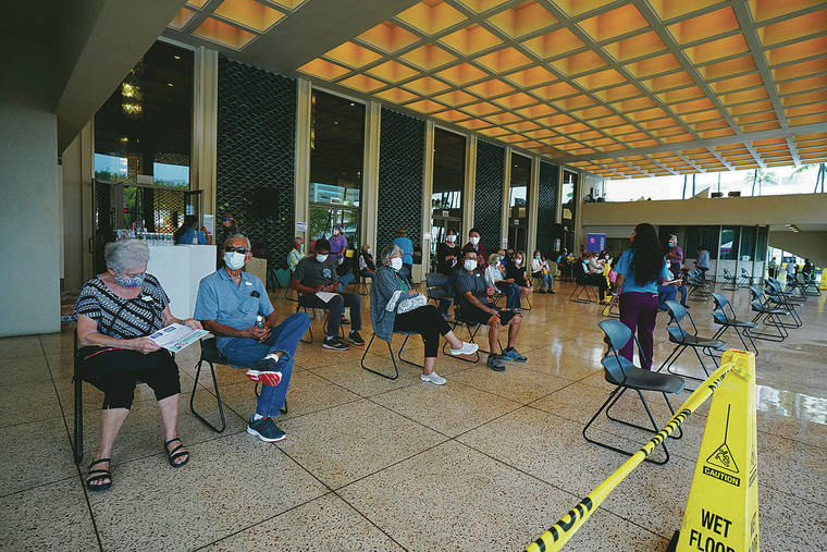 JAMM AQUINO / JAQUINO@STARADVERTISER.COM
                                Freshly inoculated patients sat Monday in the monitoring area at Blaisdell Concert Hall. The Queen’s Medical Center started its vaccination clinic with a soft opening Saturday, administering 550 doses of the Moderna COVID-19 vaccine.