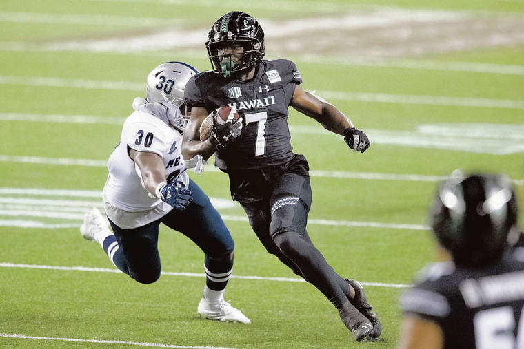 Hawaii Warriors running back Calvin Turner Jr. (7) tackled by UNLV Rebels  defensive back Camero …