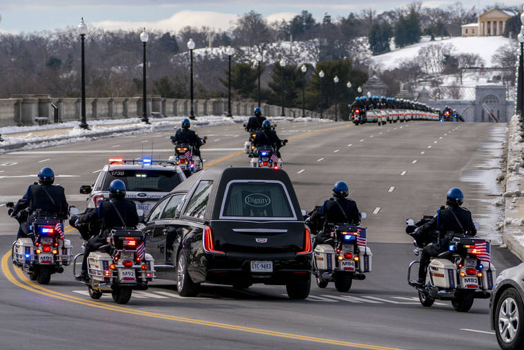 ASSOCIATED PRESS
                                A hearse carrying the remains of U.S. Capitol Police officer Brian Sicknick made its way to Arlington National Cemetery, Feb. 3, after Sicknick laid in honor at the U.S Capitol, in Washington.