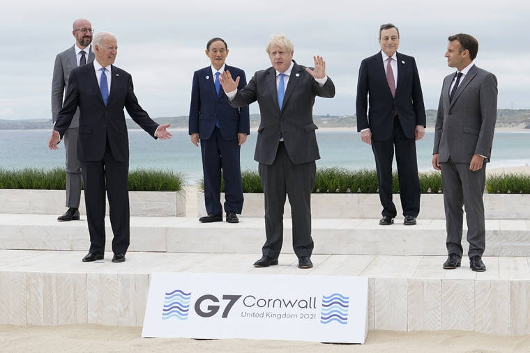 ASSOCIATED PRESS
                                President Joe Biden and British Prime Minister Boris Johnson gesture as they pose for a family photo with G-7 leaders in Carbis Bay, England, today.