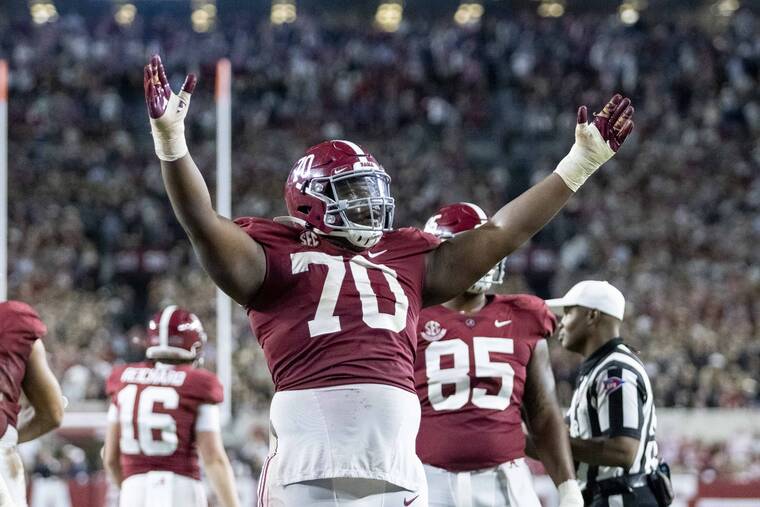 ASSOCIATED PRESS
                                Alabama offensive lineman Javion Cohen (70) signals a touchdown after a dive into the end zone by quarterback Bryce Young during the second half of an NCAA college football game against Tennessee on Saturday in Tuscaloosa, Ala.