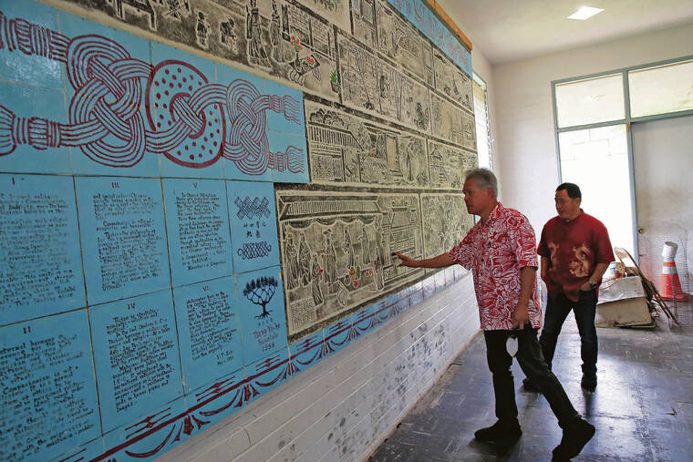 JAMM AQUINO / JAQUINO@STARADVERTISER.COM
                                Lin Yee Chung Association president Charles Wong and trustee Les Young, left, admire the 1958 mural depicting examples of filial piety in the Memorial Hall.