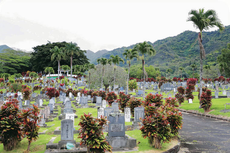 JAMM AQUINO / JAQUINO@STARADVERTISER.COM
                                Lush mountains frame the Lin Yee Chung Manoa Chinese Cemetery, which is a treasury of the culture and history of Chinese immigrants in Hawaii.