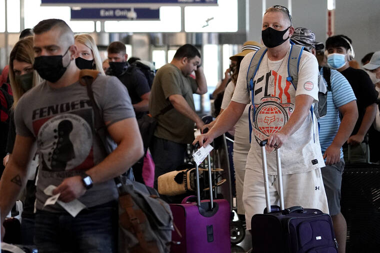 ASSOCIATED PRESS
                                Travelers lined up at O’Hare airport in Chicago, July 2. The federal requirement to wear face masks on airplanes and public transportation is scheduled to expire next week, and airline executives and Republican lawmakers are urging the Biden administration to let the mandate die.