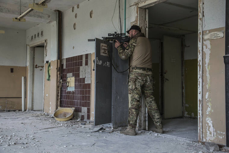 ASSOCIATED PRESS
                                A Ukrainian soldier stands in position during heavy fighting on the front line in Severodonetsk, the Luhansk region, Ukraine, Wednesday.