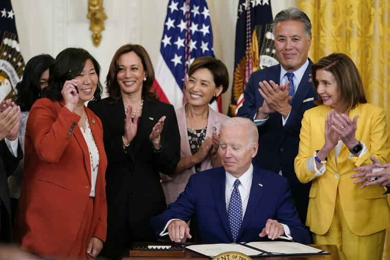 ASSOCIATED PRESS Rep. Grace Meng, D-N.Y., holds up a pen given to her by President Joe Biden during a bill signing ceremony for the Commission To Study the Potential Creation of a National Museum of Asian Pacific American History and Culture Act, today, in the East Room of the White House in Washington. Also on stage are Vice President Kamala Harris, second from left, Rep. Young Kim, R-Calif., Rep. Mark Takano, D-Calif., and House Speaker Nancy Pelosi of Calif.