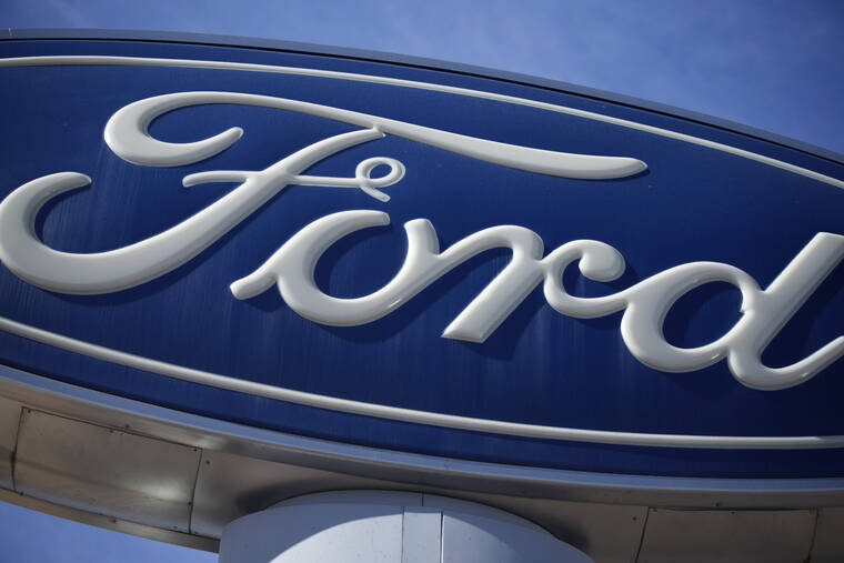 FILE - This Oct. 24, 2021 file photo shows a Ford company logo on a sign at a Ford dealership in southeast Denver. Ford is recalling over 2.9 million vehicles in the U.S., Wednesday, June 15, 2022, to fix a transmission problem that can increase the risk of inadvertent rollaway crashes. The recall covers certain 2013 to 2019 Escape, 2013 to 2018 C-Max, 2013 to 2016 Fusion, 2013 to 2021 Transit Connect, and 2015 to 2018 Edge vehicles. (AP Photo/David Zalubowski, File)