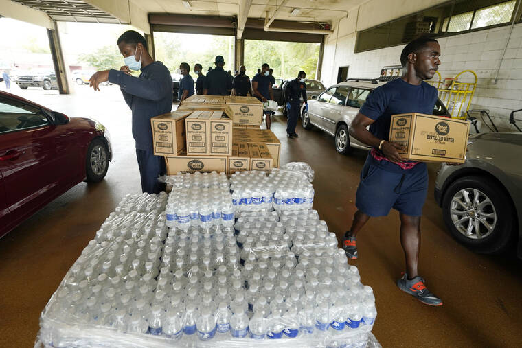 ASSOCIATED PRESS
                                Firefighters and recruits for the Jackson, Miss., Fire Department carry cases of bottled water to residents’ vehicles, Aug. 18, as part of the city’s response to longstanding water system problems. Mississippi’s capital city is grappling with multiple water problems — too much on the ground after heavy rainfall in the past week, and not enough safe water coming through the pipes for people to use.