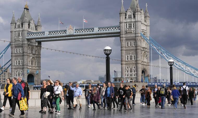 MARTIN MEISSNER / AP
                                People queue at the start of the more than four miles long line, near Tower Bridge, to pay their respect to the late Queen Elizabeth II during the Lying-in State, in Westminster Hall in London, Thursday, Sept. 15. The Queen will lie in state in Westminster Hall for four full days before her funeral on Monday Sept. 19.