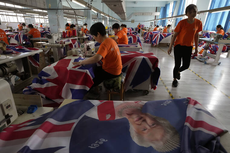 ASSOCIATED PRESS / SEPT. 16
                                Workers produce British flags at the Shaoxing Chuangdong Tour Articles Co factory in Shaoxing, in eastern China’s Zhejiang province. Ninety minutes after Queen Elizabeth II died, orders for thousands of British flags started to flood into the factory south of Shanghai.