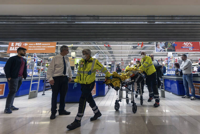 LAPRESSE / AP
                                Emergency personnel wheel an injured person at the scene of an attack in Milan, Italy, Thursday Oct. 27. A man armed with a knife stabbed five people inside a shopping center south of Milan on Thursday.