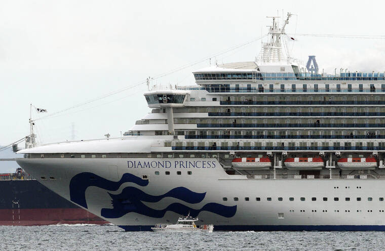 ASSOCIATED PRESS
                                A small boat navigates near the Diamond Princess cruise ship anchoring off the Yokohama Port, near Tokyo on Feb. 4, 2020. Japan is lifting a more than 2 1/2-year ban on international cruise ships that was imposed following a deadly coronavirus outbreak on the cruise ship Diamond Princess at the beginning of the pandemic.