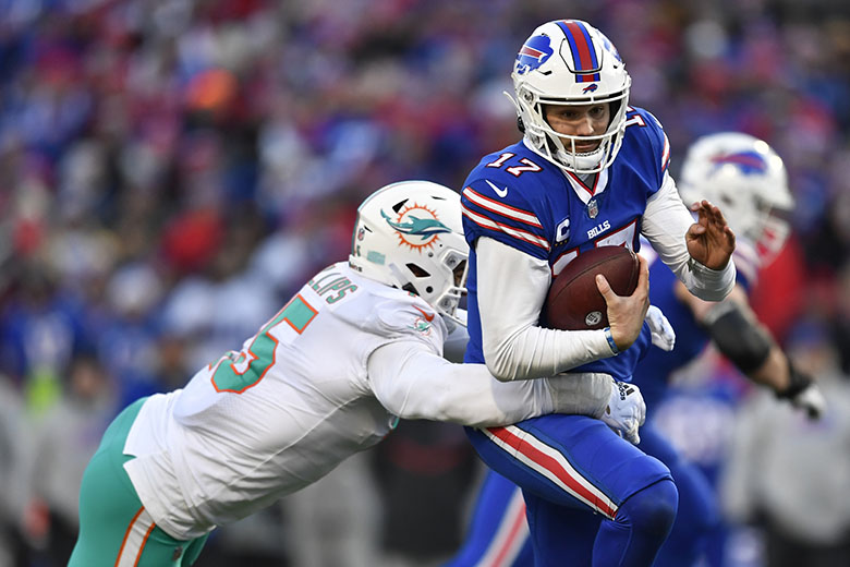 Buffalo Bills tight end Dawson Knox (88) catches a touchdown pass in front  of Miami Dolphins linebacker Jerome Baker (55) during an NFL wild-card  football game Sunday, Jan. 15, 2023, in Orchard