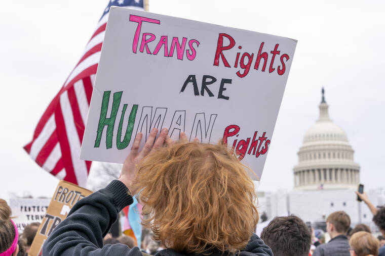 ASSOCIATED PRESS / MARCH 31
                                People attend a rally as part of a Transgender Day of Visibility, Friday, March 31, by the Capitol in Washington. Schools and colleges across the U.S. would be forbidden from enacting outright bans on transgender athletes under a proposal released Thursday, April 6, from the Biden administration, but teams could create some limits in certain cases, for example, to ensure fairness.