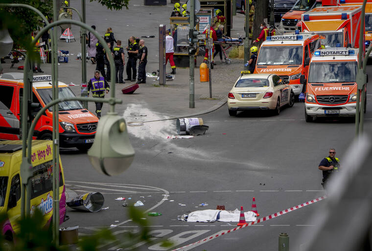 ASSOCIATED PRESS
                                A covered body, foreground, lies on the street after a car crashed into a crowd of people in central Berlin, Germany, in June 2022. A German court has convicted a 30-year-old man who drove into groups of pedestrians in Berlin last year of one count of murder and 16 counts of attempted murder, ordering him to be permanently held in a psychiatric hospital.