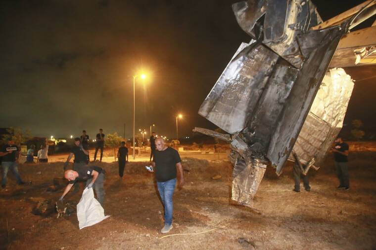 ASSOCIATED PRESS
                                Israeli authorities inspect the remains of what the military said is a Syrian anti-aircraft rocket that exploded in the air, in the town of Rahat, Israel. Israel carried out airstrikes on areas near the central Syrian city of Homs, the Syrian military said in a statement. A Syrian anti-aircraft rocket exploded over Israeli territory, the Israeli military said.