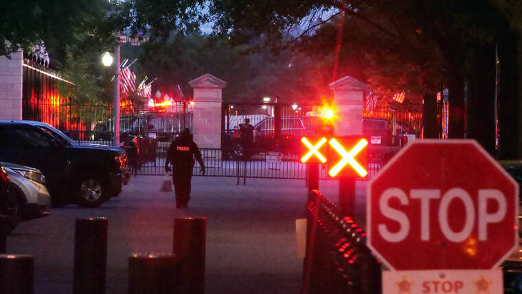 ANTHONY PELTIER VIA ASSOCIATED PRESS
                                Police are seen outside the White House grounds, Sunday night, in Washington. The White House was briefly evacuated Sunday evening while President Joe Biden was at Camp David after the Secret Service discovered a suspicious powder in a common area of the West Wing.