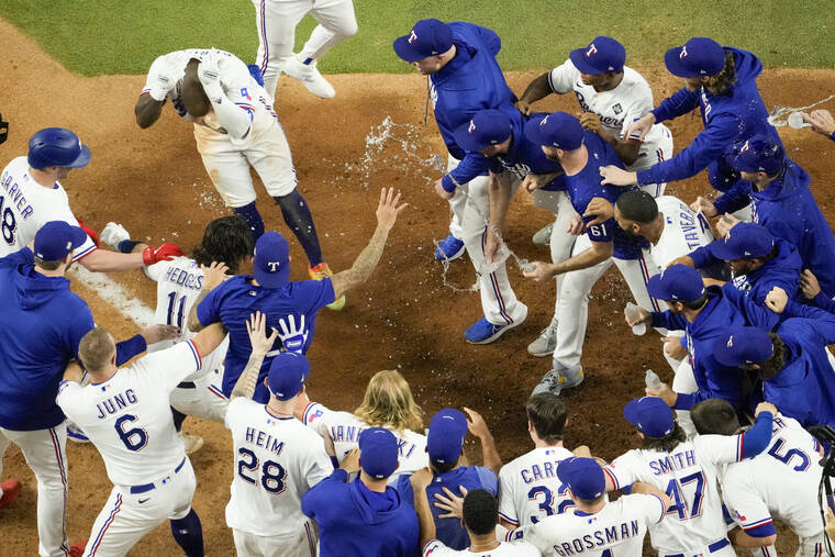 ASSOCIATED PRESS
                                Texas Rangers’ Adolis Garcia celebrates after hitting a game-winning home run against the Arizona Diamondbacks during the 11th inning.