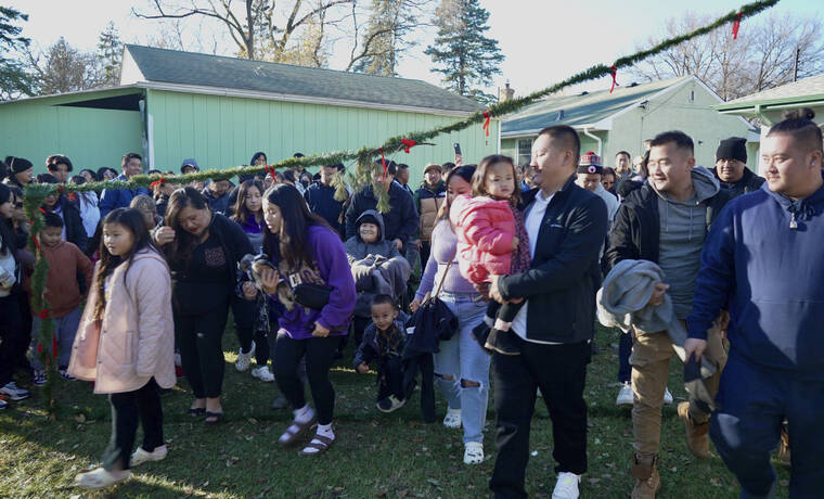 ASSOCIATED PRESS / NOV. 18
                                Family, friends and members of the Twin Cities Hmong community gather in the backyard of Nhia Neng Vang for a Hmong New Year sweeping ritual in St. Paul, Minn. on Saturday, Nov. 18. The ritual, in which participants walk together in circles, first to the west and then to the east, represents leaving old negative spirits behind and embracing the new year.