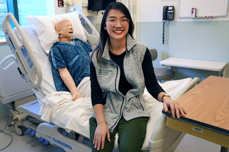 ASSOCIATED PRESS
                                Andy Hoang, a recent nursing graduate, poses with a training mannequin in a patient bedroom training lab at Dartmouth-Hitchcock Medical Center, Tuesday, Dec. 5, in Lebanon, N.H. Hoang, 23, started to feel dizzy and nauseous during the recent cardiac training session at the hospital and needed help immediately. Instead of practicing chest compressions on a mannequin in the simulated environment of their training, her four colleagues sprung into action and went to work on her.