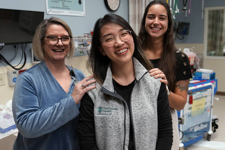 ASSOCIATED PRESS
                                Andy Hoang, a recent nursing graduate, center, poses with co-workers Lisa Davenport, left, and Justina Terino at the spot where she was stricken recently during a cardiac training session at the Dartmouth-Hitchcock Medical Center, Tuesday, Dec. 5, in Lebanon, N.H. Hoang, 23, started to feel dizzy and nauseous during training at the hospital and needed help immediately. Instead of practicing chest compressions on a mannequin in the simulated environment of their training, her four colleagues sprung into action and went to work on her.