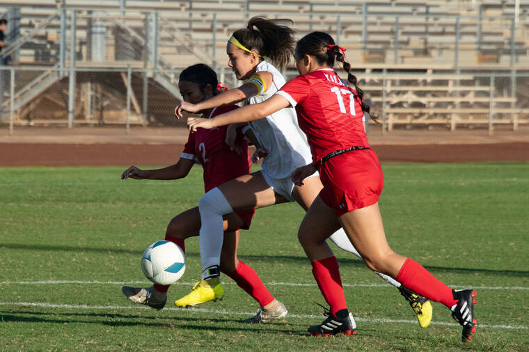 CRAIG T. KOJIMA / CKOJIMA@STARADVERTISER.COM
                                Leilehua’s Alexyz Nakamoto, middle, scores goal in first half.