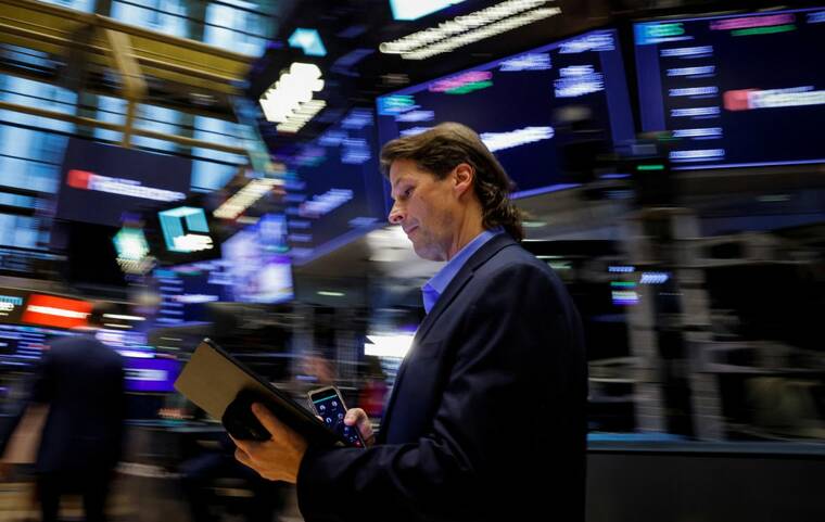 Dow closes at record high on tame inflation report