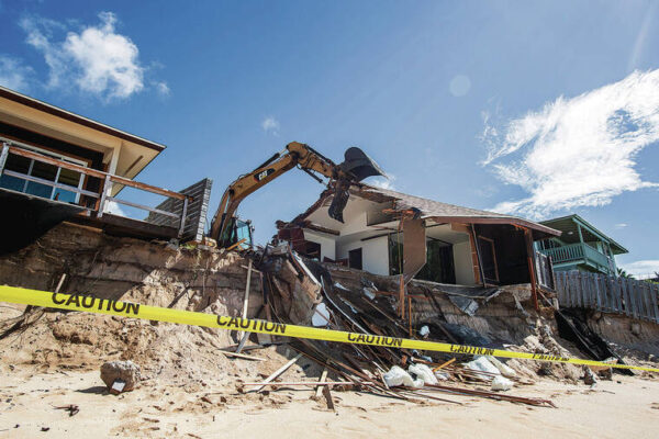 Crew demolishing partially collapsed North Shore home