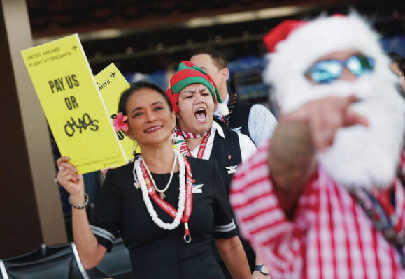 United flight attendants rally at Honolulu airport before travel rush