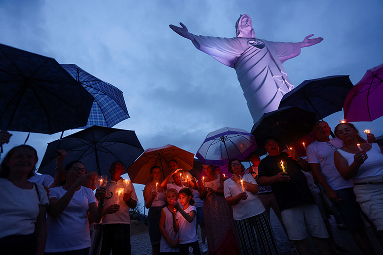 People pray as Pope Francis continues hospitalization at the Vatican